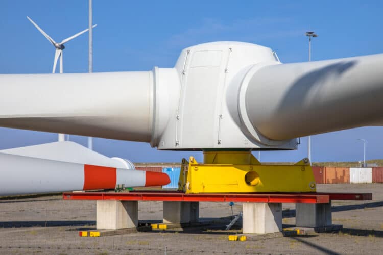 An image of the rotors of a wind turbine at a construction yard