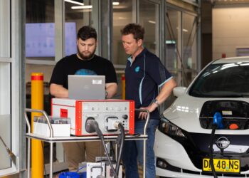 Engineers at CSIRO's Renewable Energy Infrastructure Facility configuring a vehicle-to-home (V2H) experiment. Image: CSIRO
