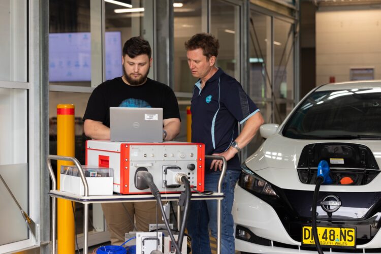 Engineers at CSIRO's Renewable Energy Infrastructure Facility configuring a vehicle-to-home (V2H) experiment. Image: CSIRO